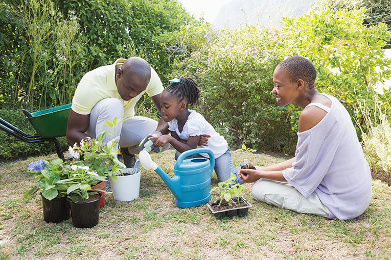 Happy Smiling Family Plant A Flowers Together